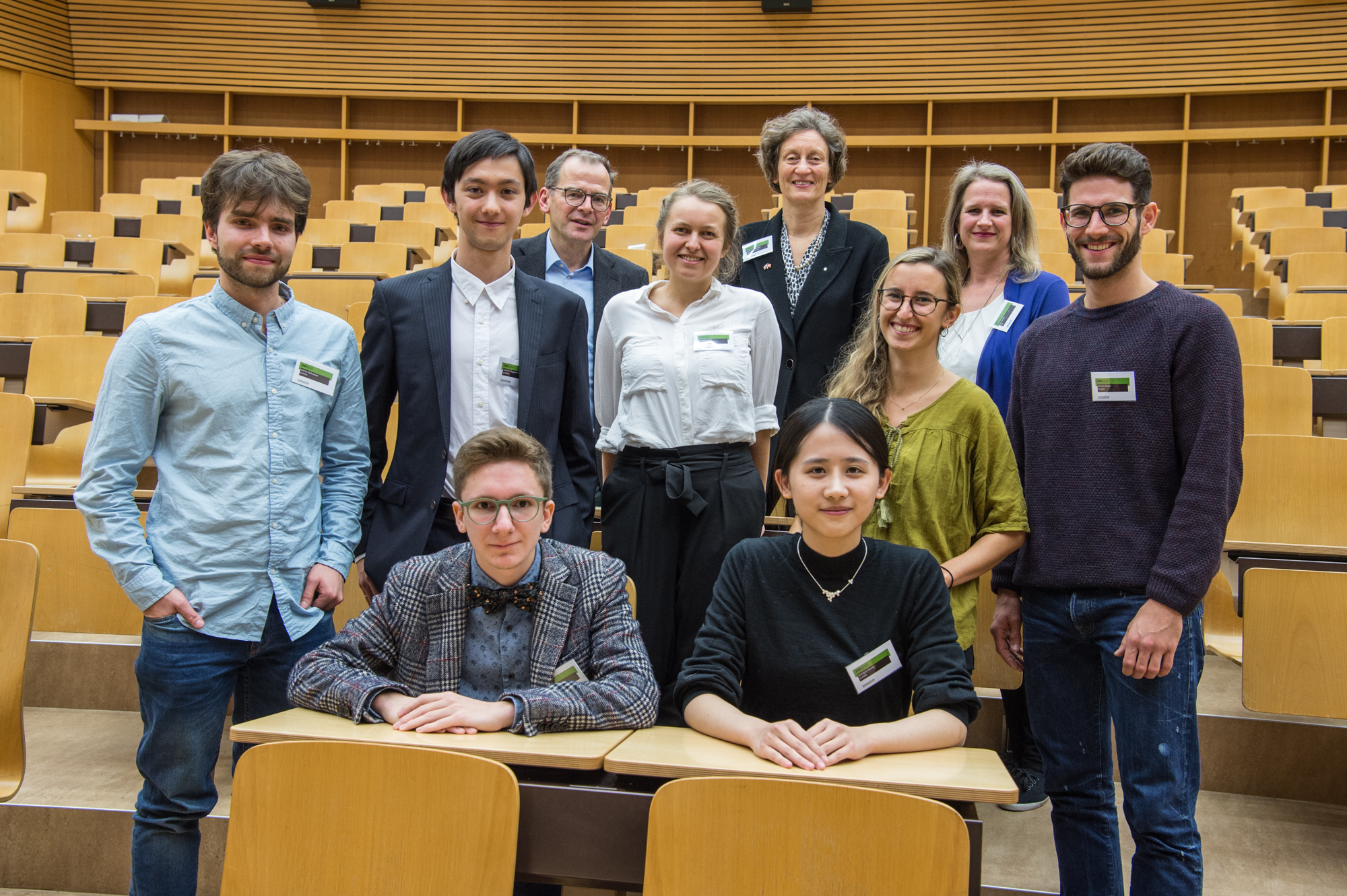 A group of students stand facing the camera. 